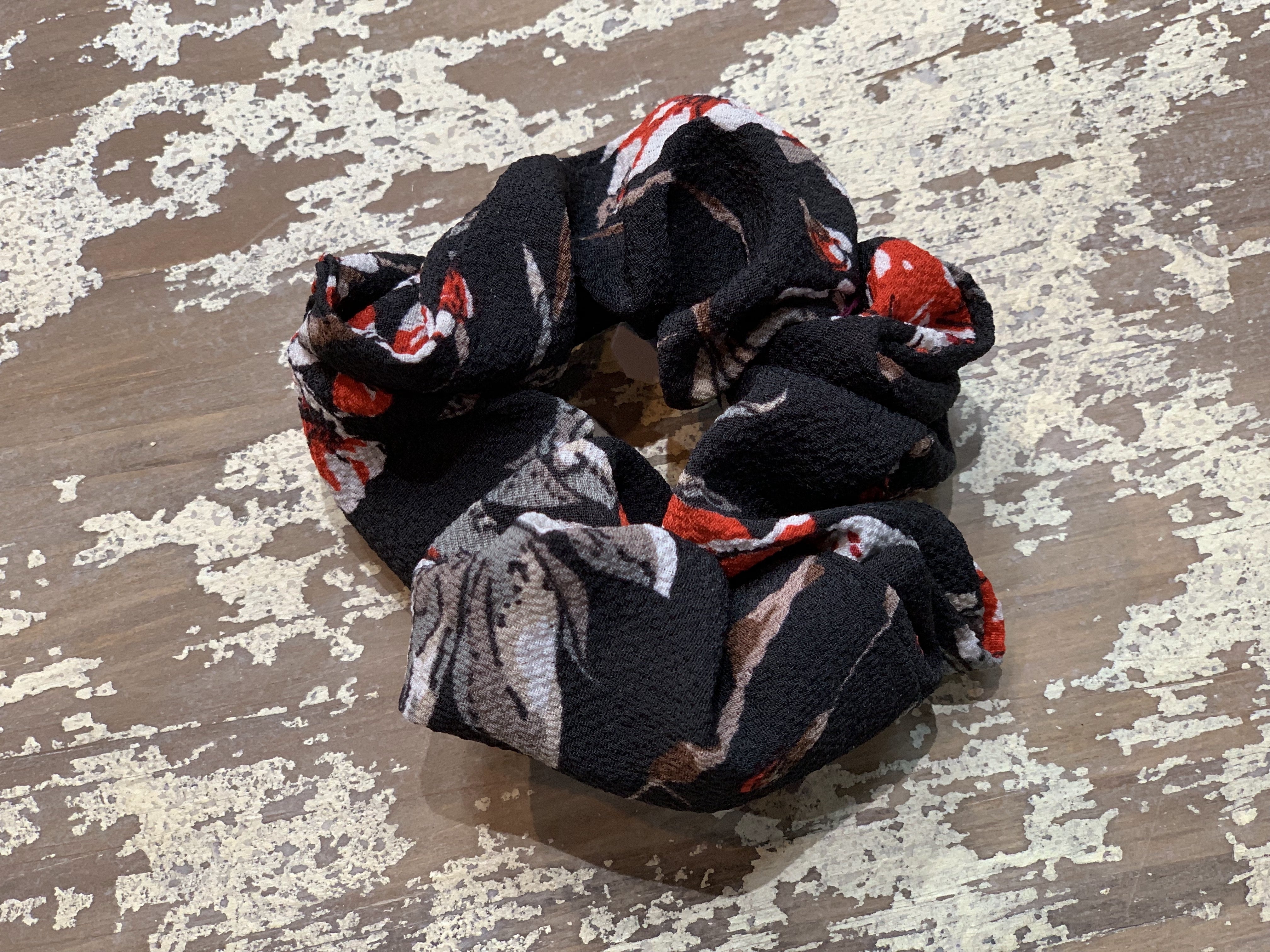 an oversized floral scrunchie with lightweight textured fabric, gathered construction, gentle hair-friendly hold, and easy pull-on styling in black