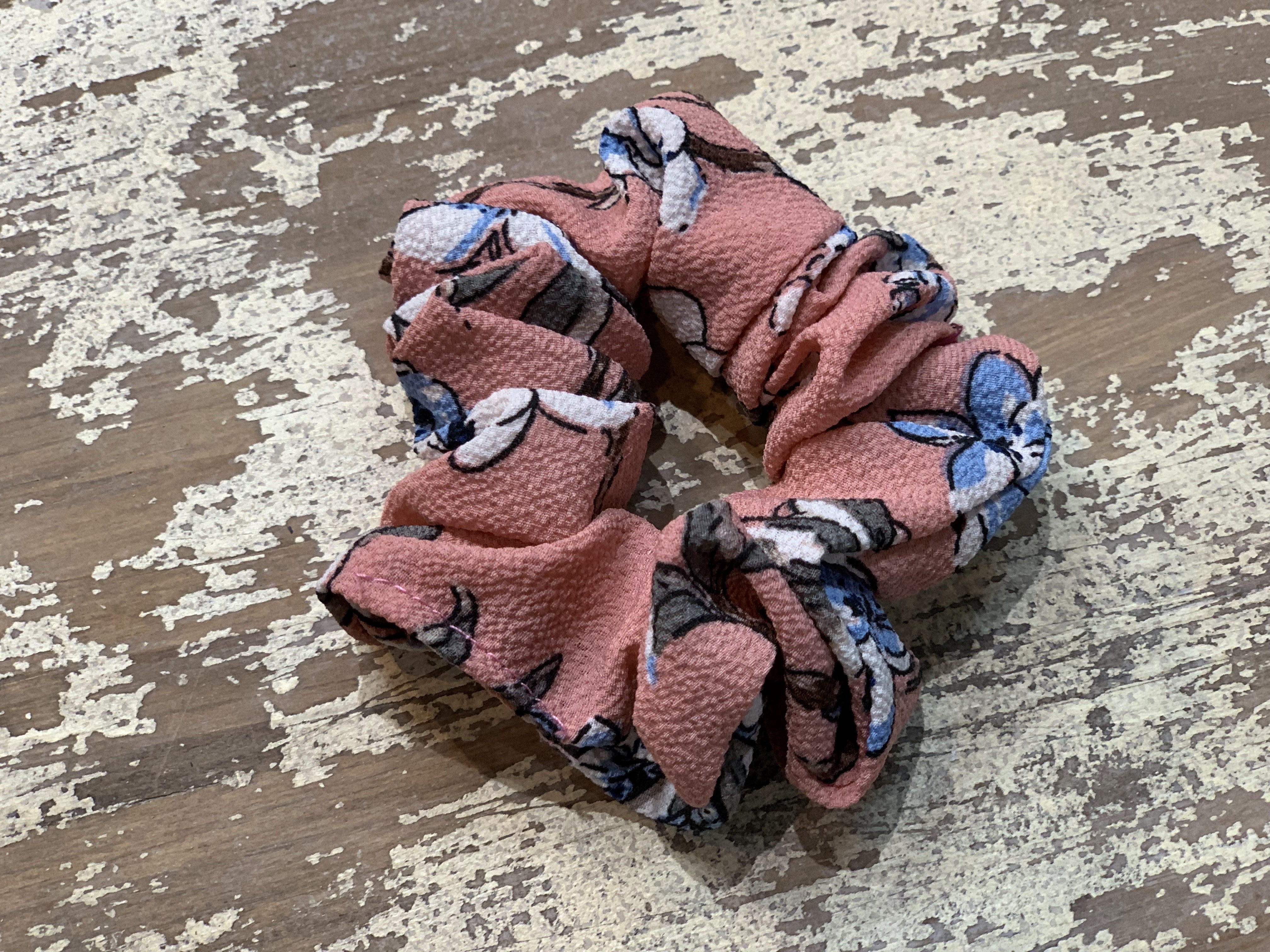 an oversized floral scrunchie with lightweight textured fabric, gathered construction, gentle hair-friendly hold, and easy pull-on styling in mauve