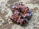 an oversized floral scrunchie with lightweight textured fabric, gathered construction, gentle hair-friendly hold, and easy pull-on styling in mauve