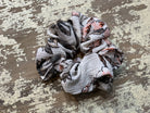 an oversized floral scrunchie with lightweight textured fabric, gathered construction, gentle hair-friendly hold, and easy pull-on styling in white