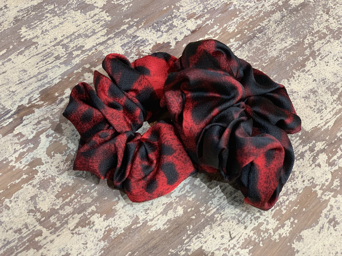 an oversized satin-look leopard scrunchie with glossy animal print fabric, plush gathered construction, lightweight feel, and gentle hair-friendly hold in leopard rose