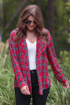 lightweight top with functional buttons, a collared neckline, roll-tab long sleeves, and a high low round hemline on a red plaid pattern