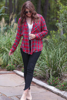 lightweight top with functional buttons, a collared neckline, roll-tab long sleeves, and a high low round hemline on a red plaid pattern