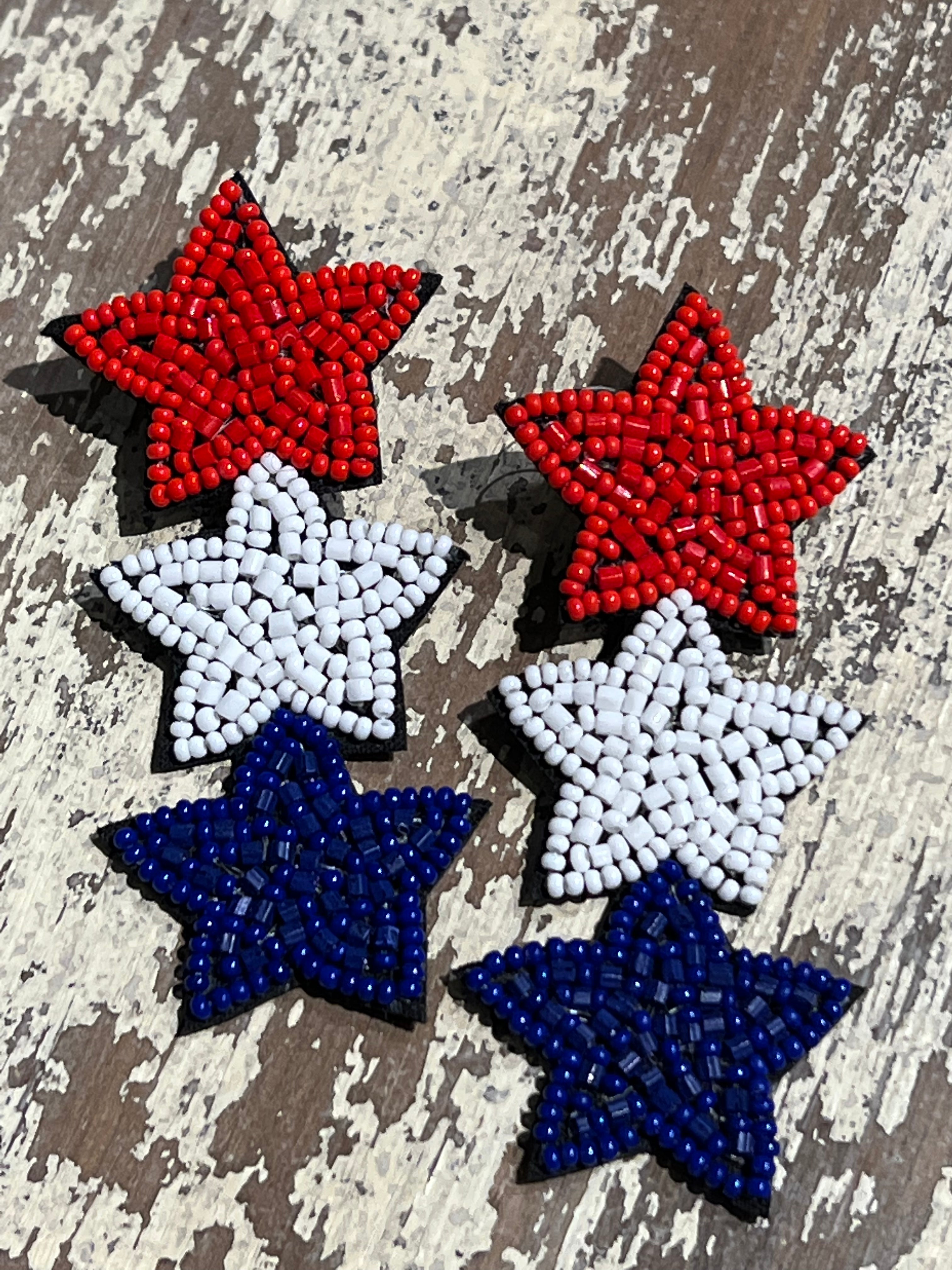 Americana-inspired beaded star earrings with red, white, and blue details, felt backing, and a push-back closure