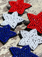 Americana-inspired beaded star earrings with red, white, and blue details, felt backing, and a push-back closure