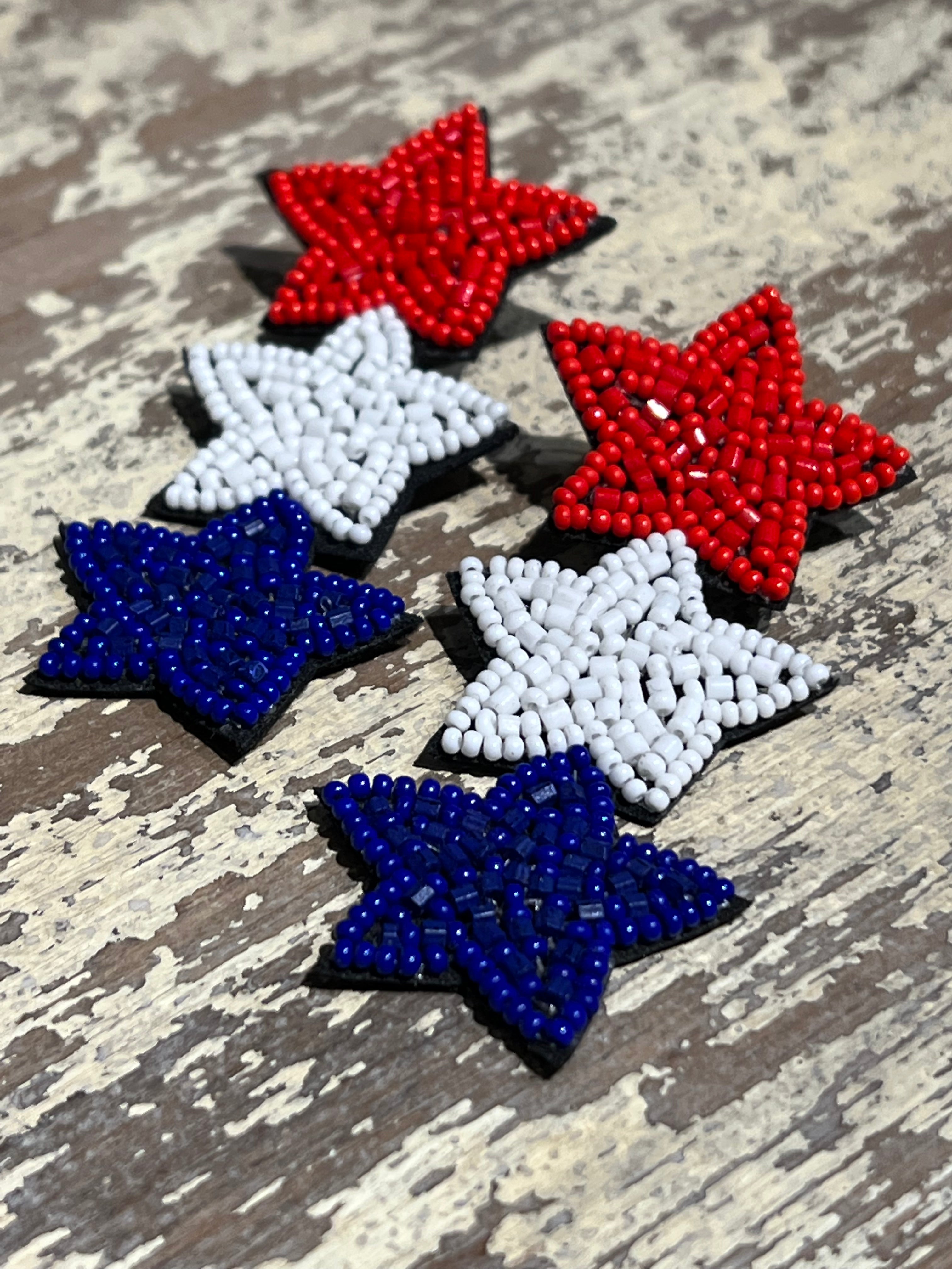 Americana-inspired beaded star earrings with red, white, and blue details, felt backing, and a push-back closure