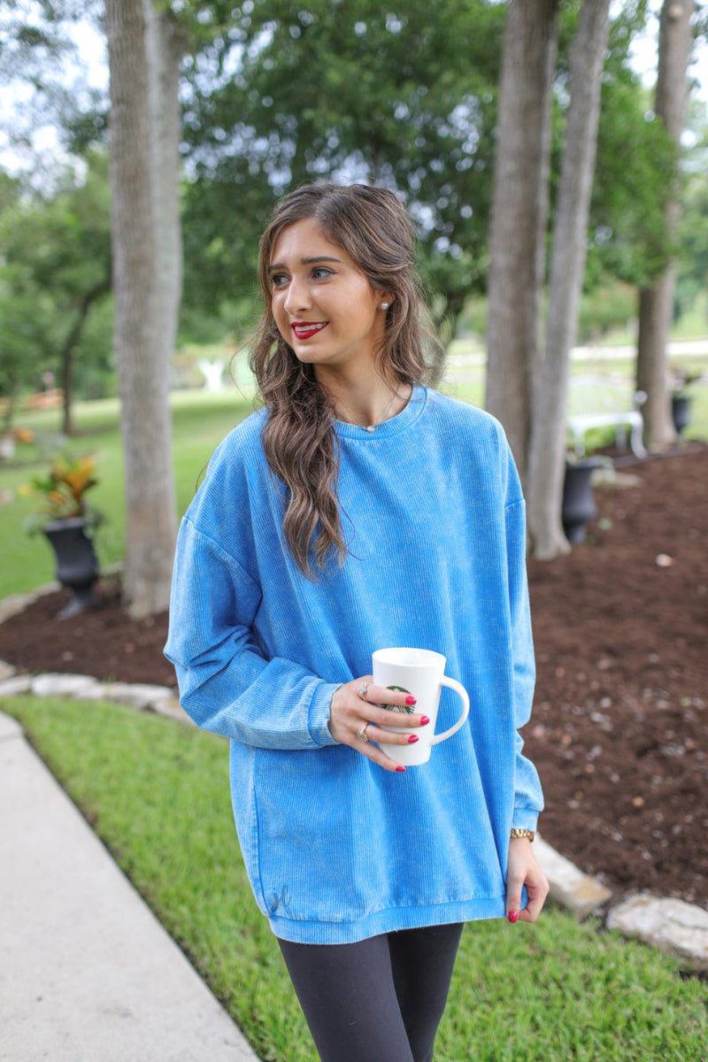 a long-sleeve ribbed textured pullover with a crew neck collar, a vintage wash, and a relaxed fit in blue