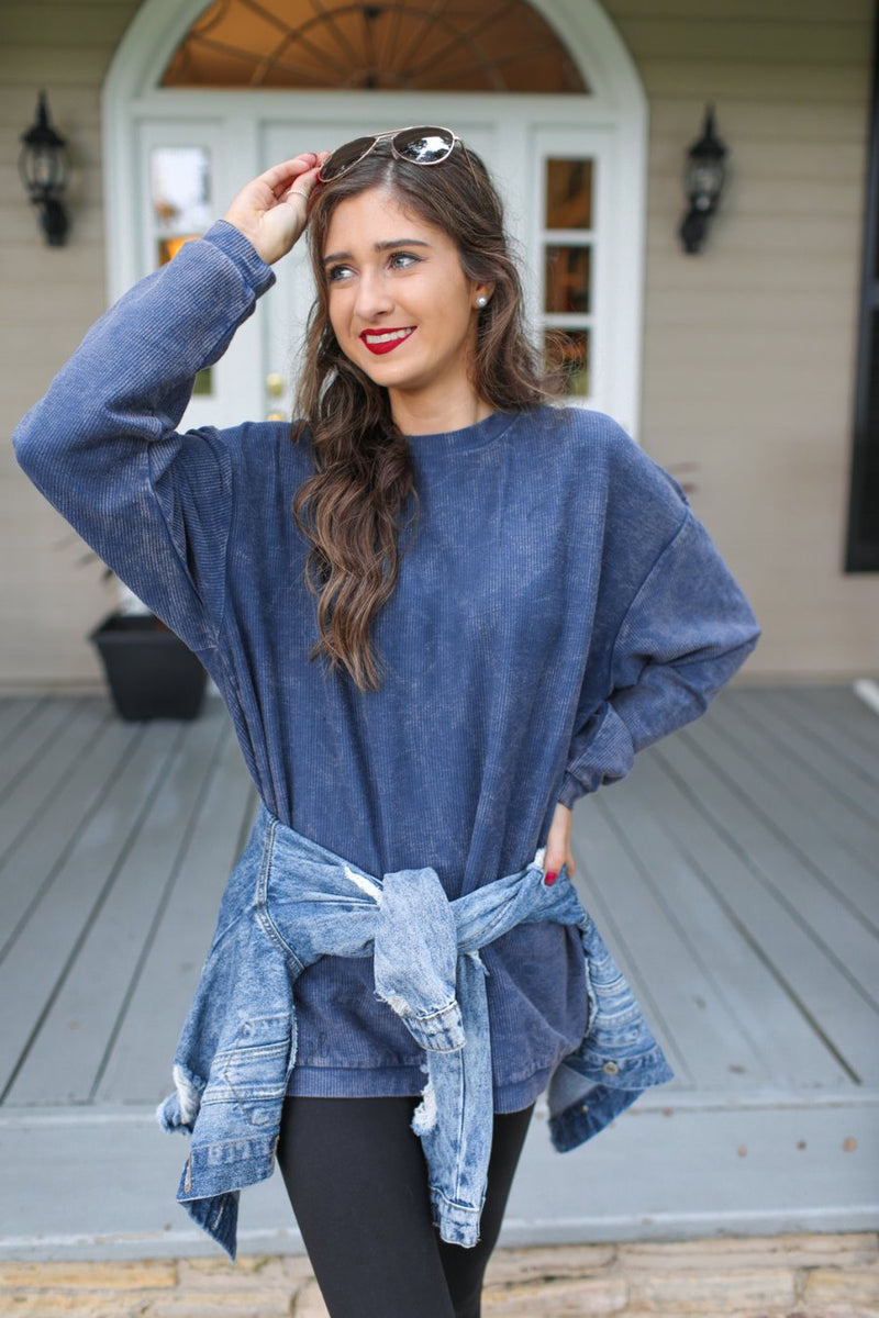 a long-sleeve ribbed textured pullover with a crew neck collar, a vintage wash, and a relaxed fit in navy