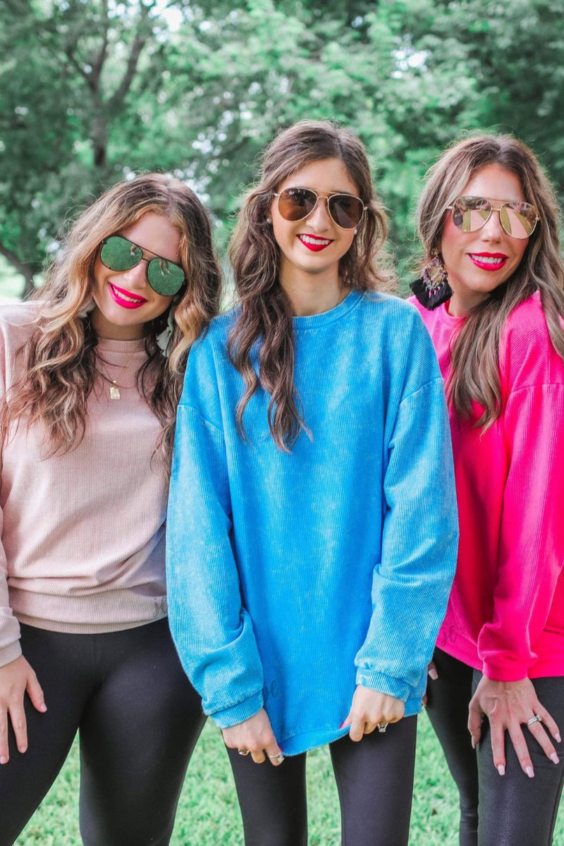 a long-sleeve ribbed textured pullover with a crew neck collar, a vintage wash, and a relaxed fit in blush, blue, and pink