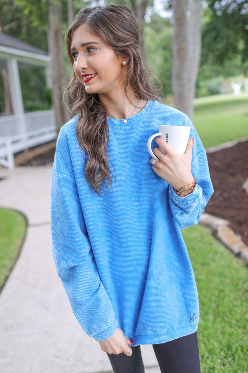 a long-sleeve ribbed textured pullover with a crew neck collar, a vintage wash, and a relaxed fit in blue