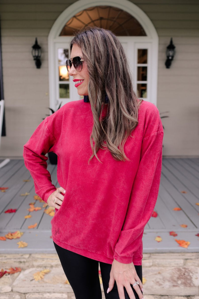 a long-sleeve ribbed textured pullover with a crew neck collar, a vintage wash, and a relaxed fit in red
