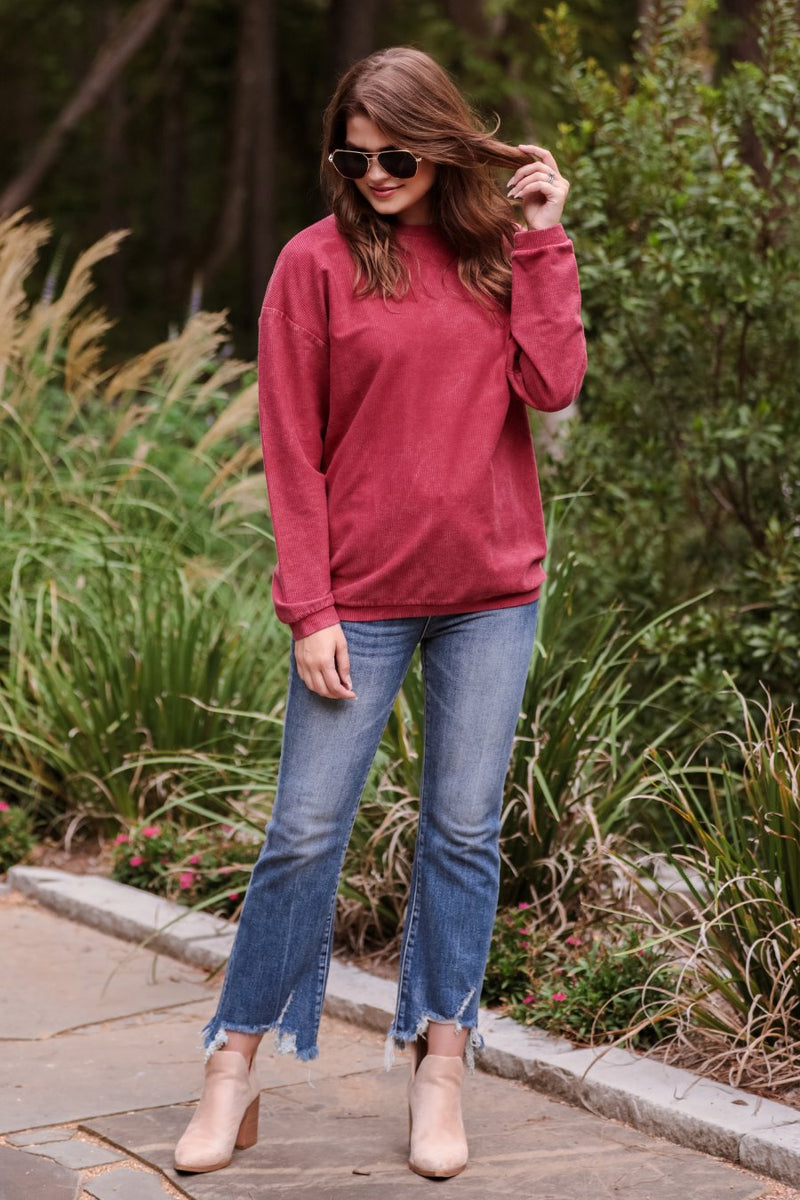 a long-sleeve ribbed textured pullover with a crew neck collar, a vintage wash, and a relaxed fit in red
