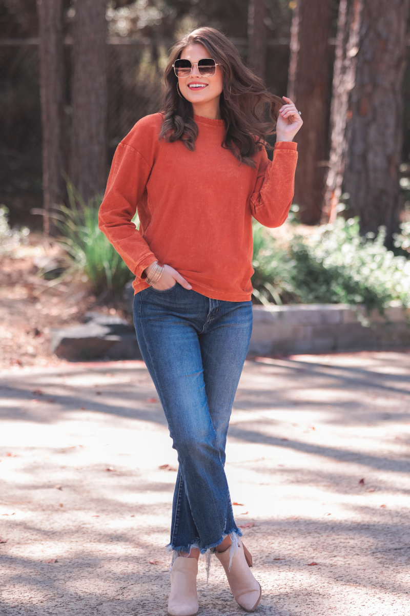 a long-sleeve ribbed textured pullover with a crew neck collar, a vintage wash, and a relaxed fit in rust