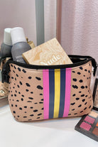 neoprene cosmetic bag in a classic animal print with dual top zippers (black), expandable side snaps (silver), and racing stripes (gold, navy, and pink)