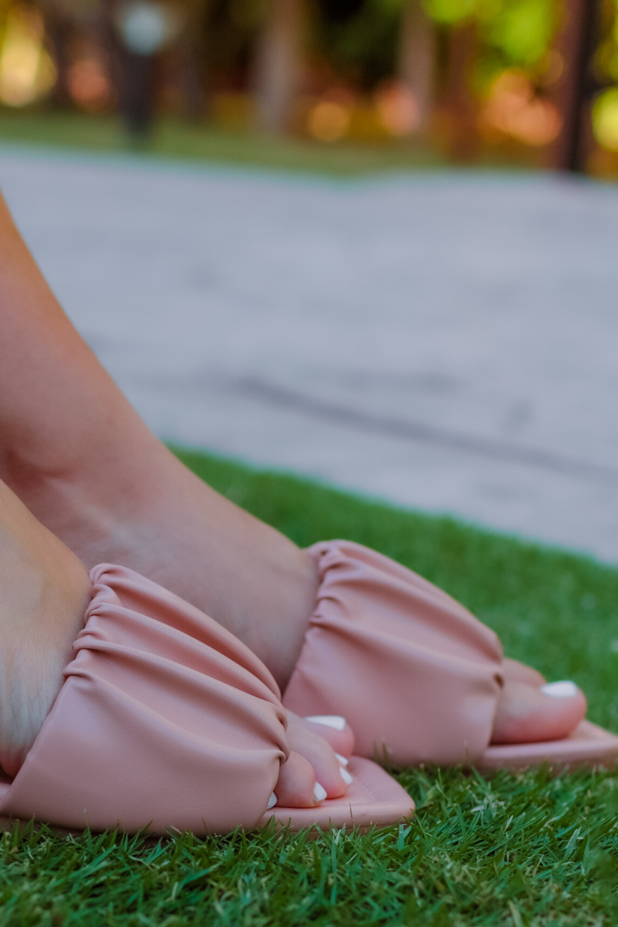 ruched slip-on sandals with an open toe and flat sole in neutral