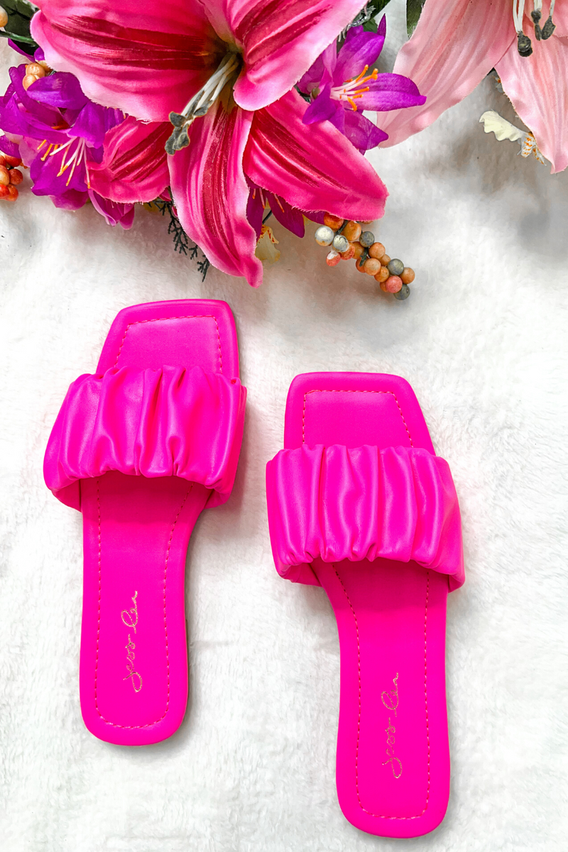 ruched slip-on sandals with an open toe and flat sole in pink