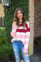 long sleeve sweater made of soft knitted material with colorful stripes in shades of pink in reverse ombré