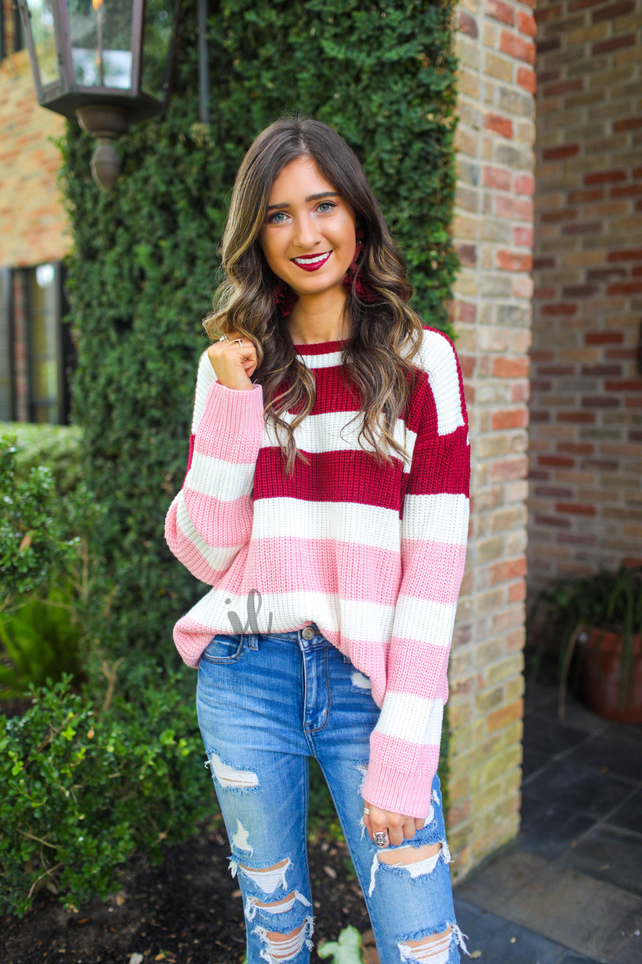 long sleeve sweater made of soft knitted material with colorful stripes in shades of pink in reverse ombré