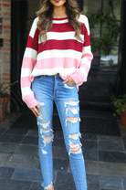 long sleeve sweater made of soft knitted material with colorful stripes in shades of pink in reverse ombré