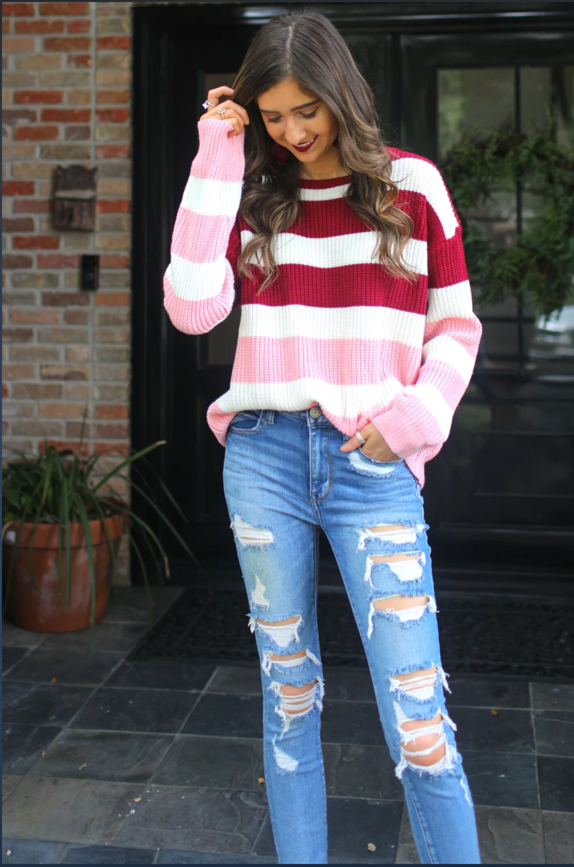 long sleeve sweater made of soft knitted material with colorful stripes in shades of pink in reverse ombré