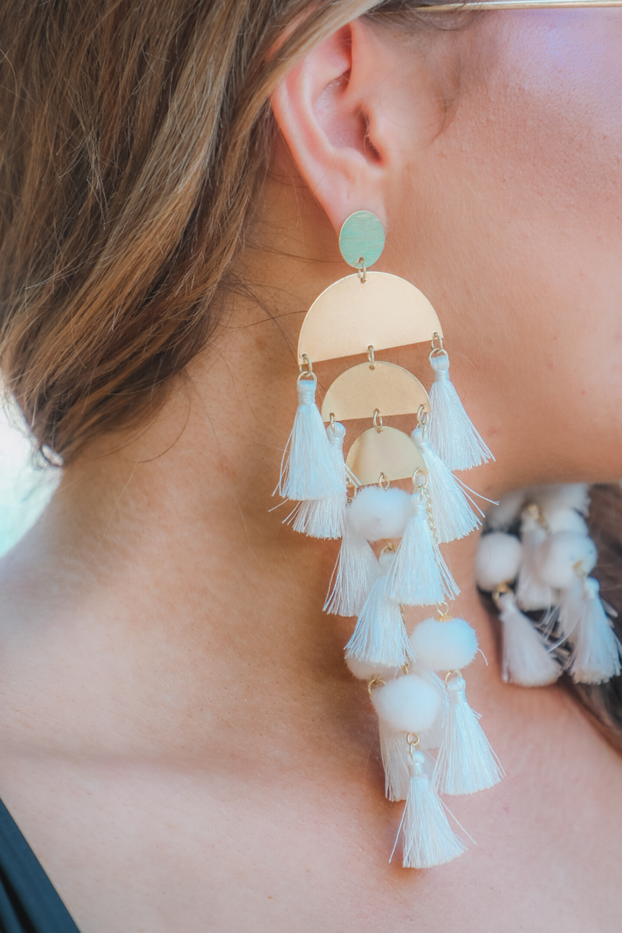 stud earrings with multi-layers of tassels in bold colors, gold bullet earring backs, and clear rubber stoppers in white