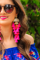 stud earrings with multi-layers of tassels in bold colors, gold bullet earring backs, and clear rubber stoppers in hot pink