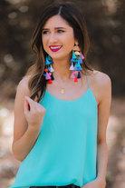 stud earrings with multi-layers of tassels in bold colors, gold bullet earring backs, and clear rubber stoppers in multi