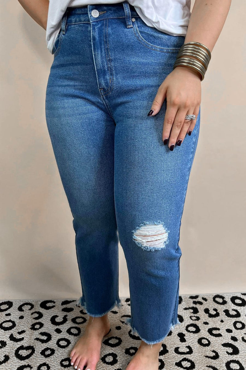 mid-rise distressed mom jeans with a raw hem, zip button-up fly, pockets, and some great stretch