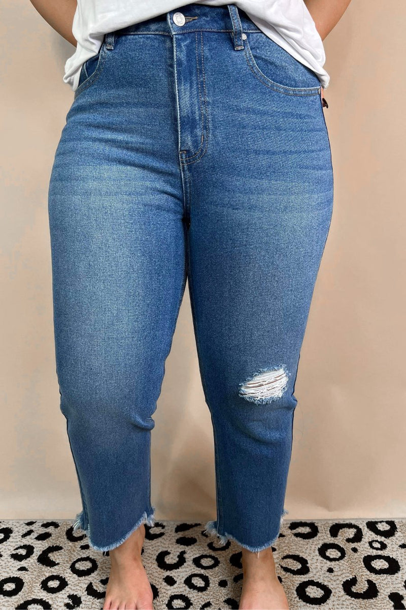 mid-rise distressed mom jeans with a raw hem, zip button-up fly, pockets, and some great stretch