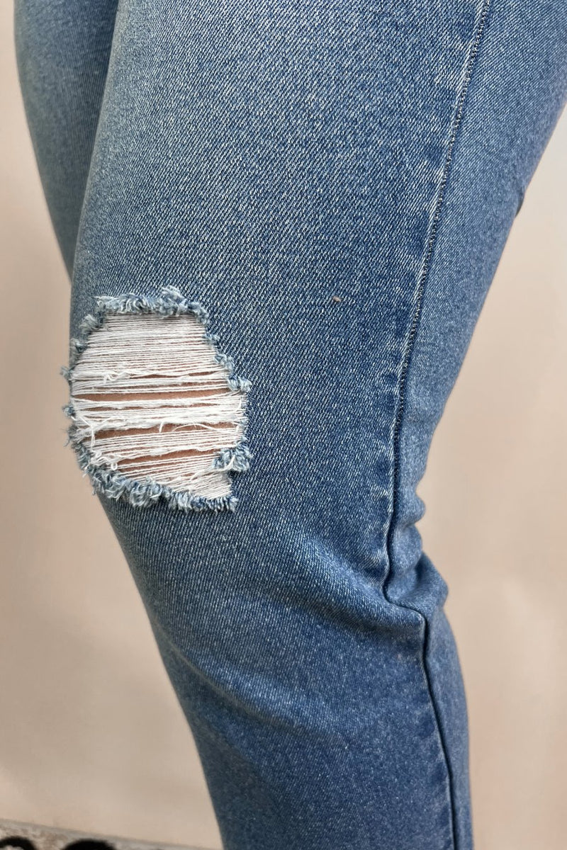 mid-rise distressed mom jeans with a raw hem, zip button-up fly, pockets, and some great stretch