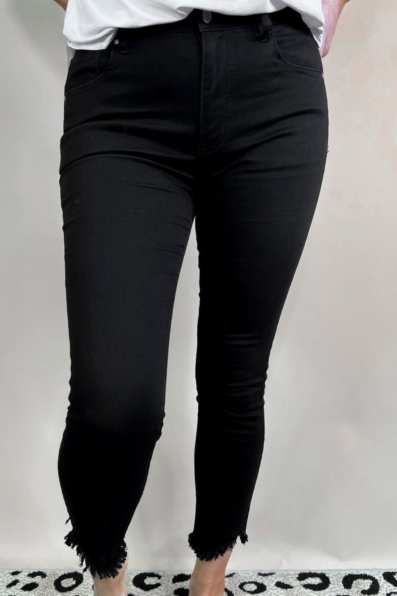 solid black mid-rise jeans with a distressed hem, zip button-up fly, pockets, and some great stretch