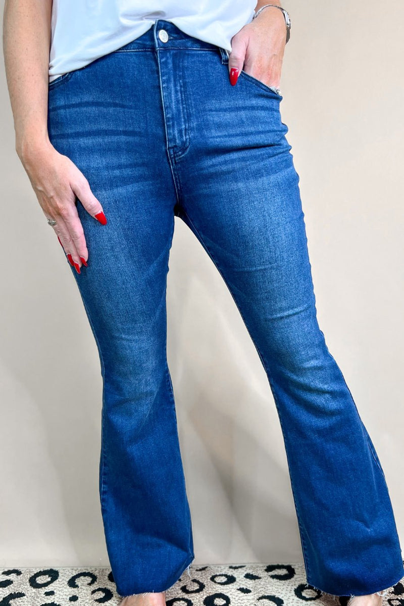 mid-rise dark denim flare skinny jeans with a raw hem, zip button-up fly, pockets, and some great stretch