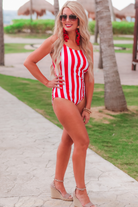 red and white vertical stripe one-piece swimsuit with ruffle sleeves, crisscross straps, removable padding, and an open front