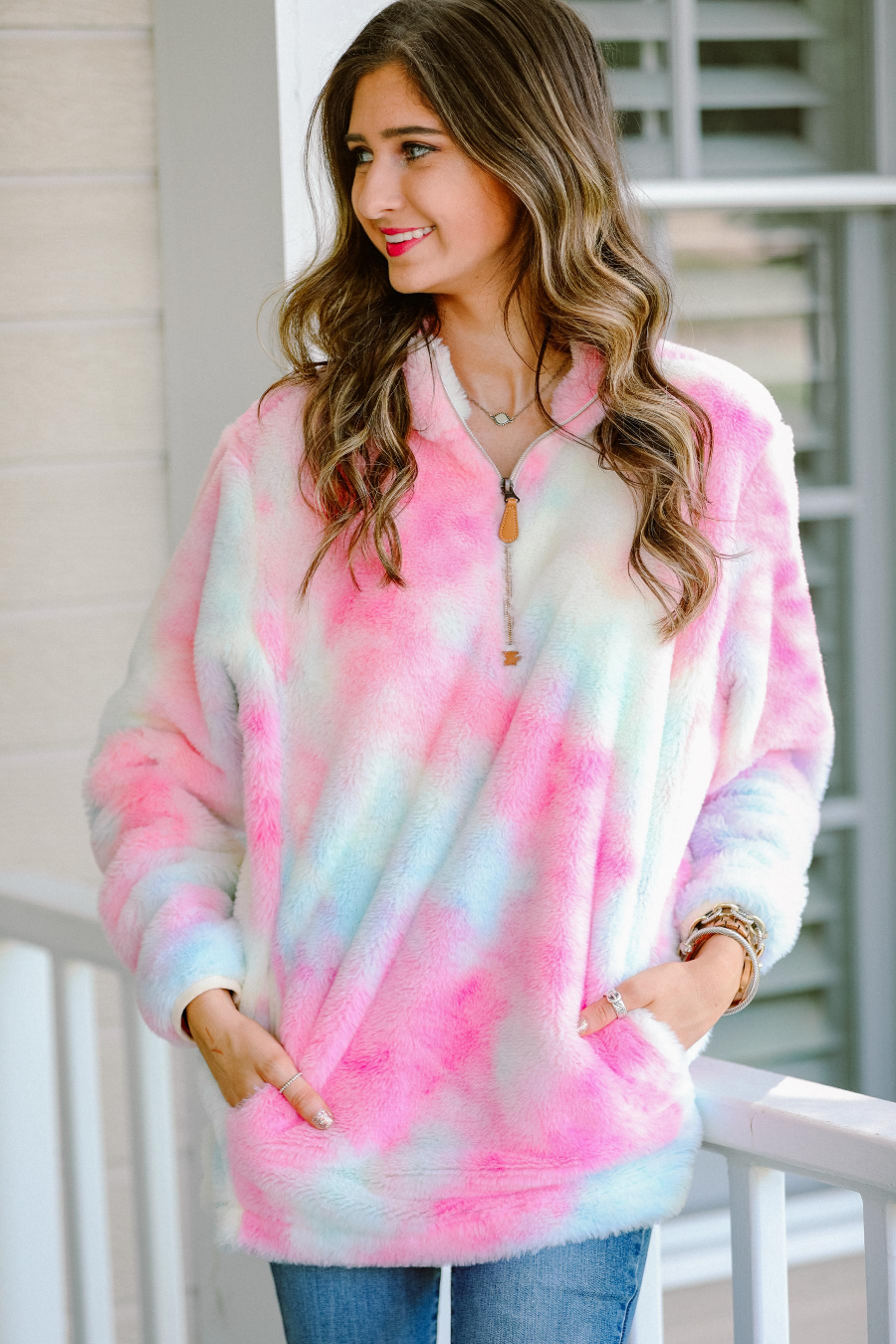 a long-sleeve plush pullover with quarter zip, front pockets, and a foldable collar on a super soft tie-dye fabric