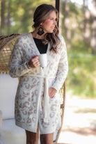 long sleeve wrap robe patterned with animal print, a straight mid-thigh length hemline, and a relaxed open front silhouette with a belt closure made of super soft material in ivory leopard pattern