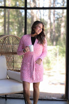 long sleeve wrap robe patterned with animal print, a straight mid-thigh length hemline, and a relaxed open front silhouette with a belt closure made of super soft material in pink spotted pattern