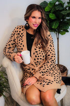 long sleeve wrap robe patterned with animal print, a straight mid-thigh length hemline, and a relaxed open front silhouette with a belt closure made of super soft material in brown spotted pattern