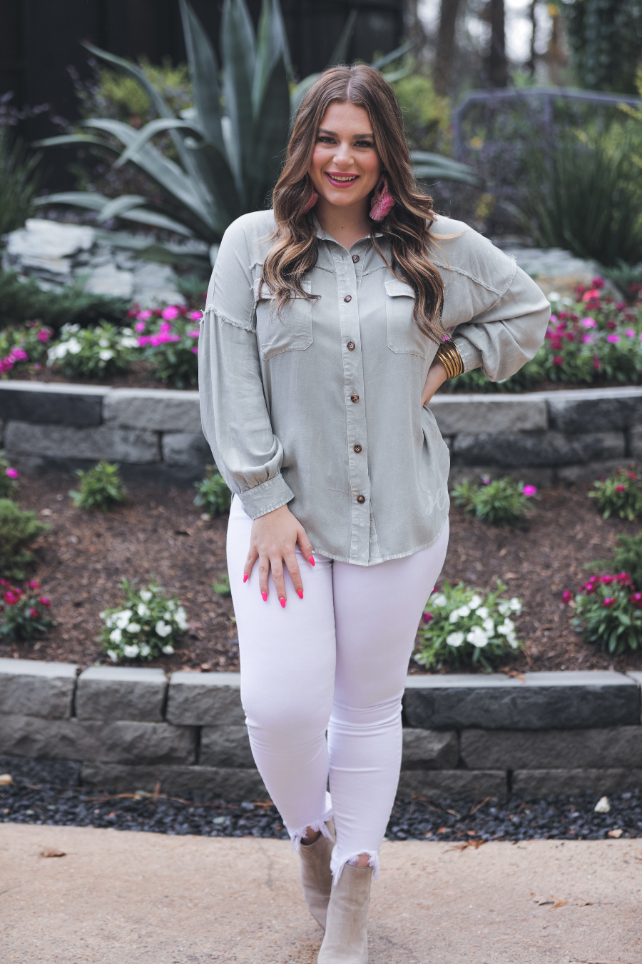 loose long-sleeve top made of soft lightweight material with a button up front, a collared neckline, button closure cuffs, two oversized accent chest pockets, and a slouched silhouette that falls into a rounded hemline with an oversized fit on an acid-washed colored fabric in grey