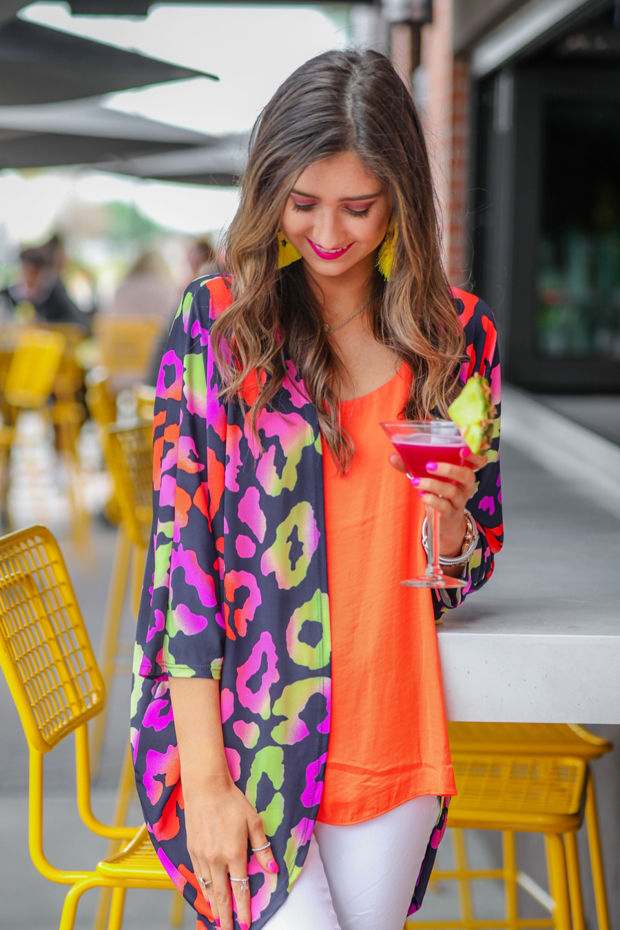 three-quarter sleeve open front cardigan made of lightweight material that drapes into a cocoon shape on a vibrant leopard print pattern fabric in navy