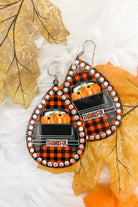 lightweight, seasonal-inspired leopard-theme teardrop-shaped earrings outlined in rhinestones with a fish hook in buffalo plaid pumpkin truck