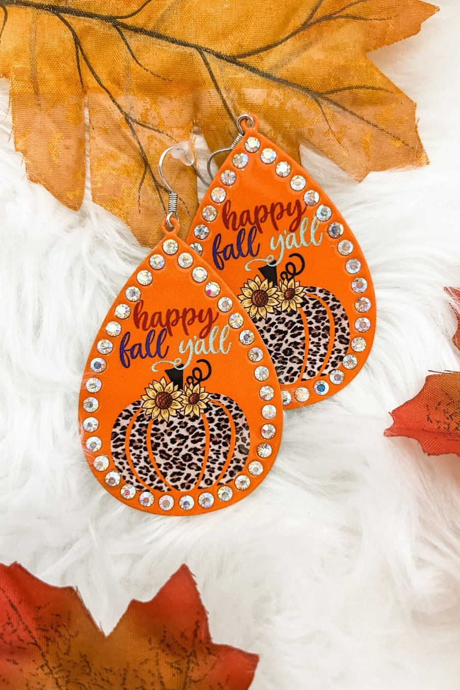 lightweight, seasonal-inspired leopard-theme teardrop-shaped earrings outlined in rhinestones with a fish hook in orange leopard pumpkin