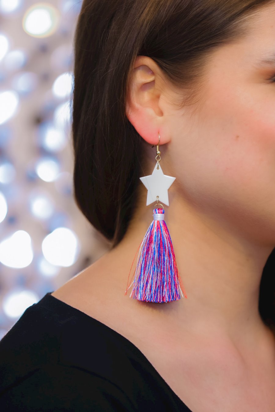 ultra-lightweight hook-style drop earring with a white star topper cascading down into a soft red, white, and blue tassel mix and gold accent