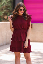 ruffled sleeve dress with layered pleats, an elastic waistband, and a lined bottom in burgundy