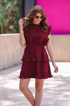 ruffled sleeve dress with layered pleats, an elastic waistband, and a lined bottom in burgundy