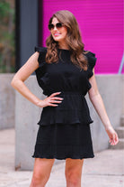 ruffled sleeve dress with layered pleats, an elastic waistband, and a lined bottom in black