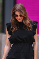 ruffled sleeve dress with layered pleats, an elastic waistband, and a lined bottom in black