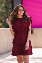 ruffled sleeve dress with layered pleats, an elastic waistband, and a lined bottom in burgundy