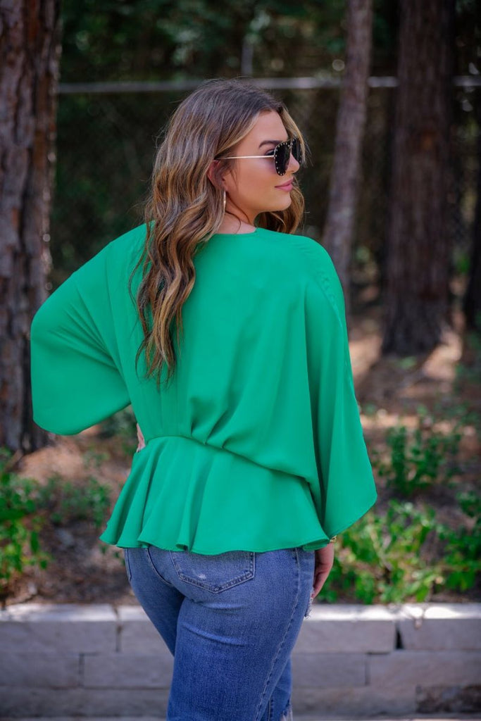 dolman long sleeves top with a plunging v-neckline and a gathered waistline in green