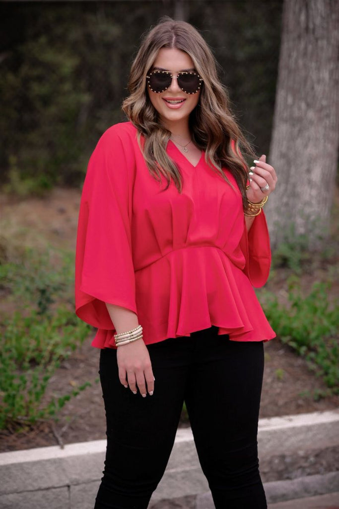 dolman long sleeves top with a plunging v-neckline and a gathered waistline in red