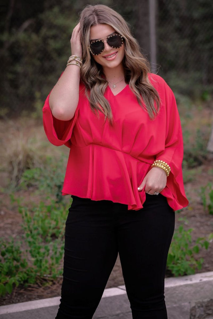 dolman long sleeves top with a plunging v-neckline and a gathered waistline in red